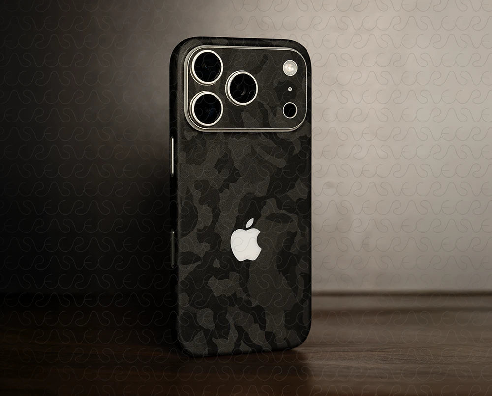 Phone case with camouflage pattern and Apple logo on a textured wall background