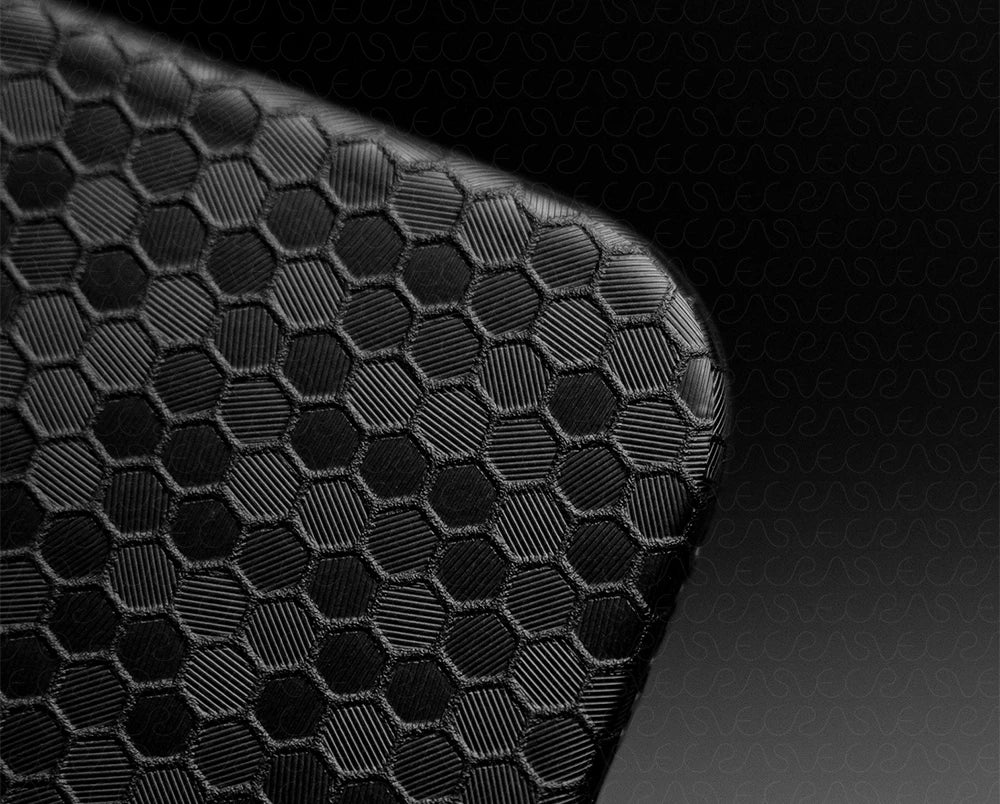 Close-up of a black textured surface with a honeycomb pattern
