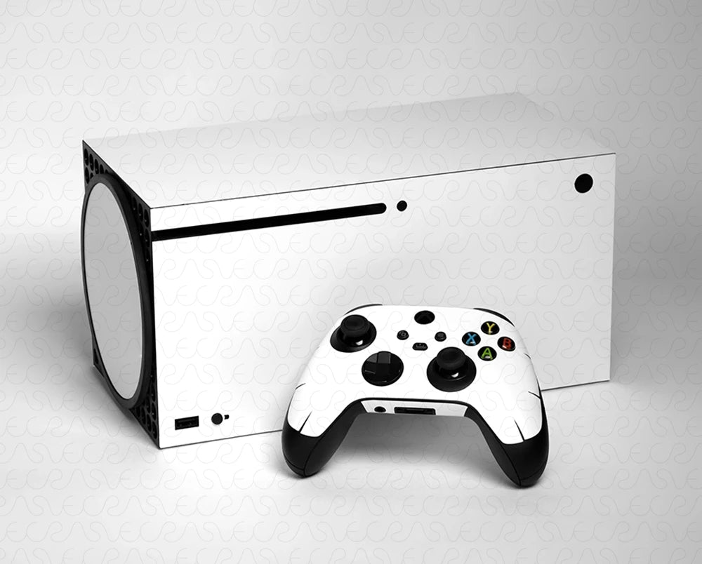 White gaming console and controller on a light gray background